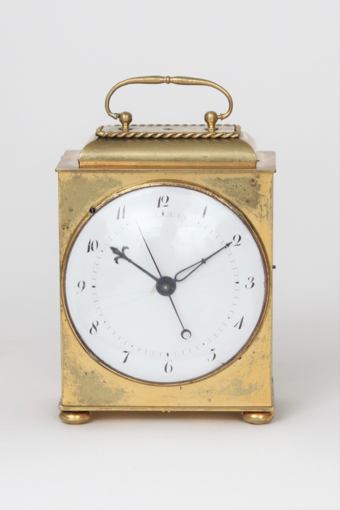 A rare and small French gilt brass travel clock with experimental