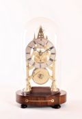 A small English brass skeleton clock with balance wheel, circa