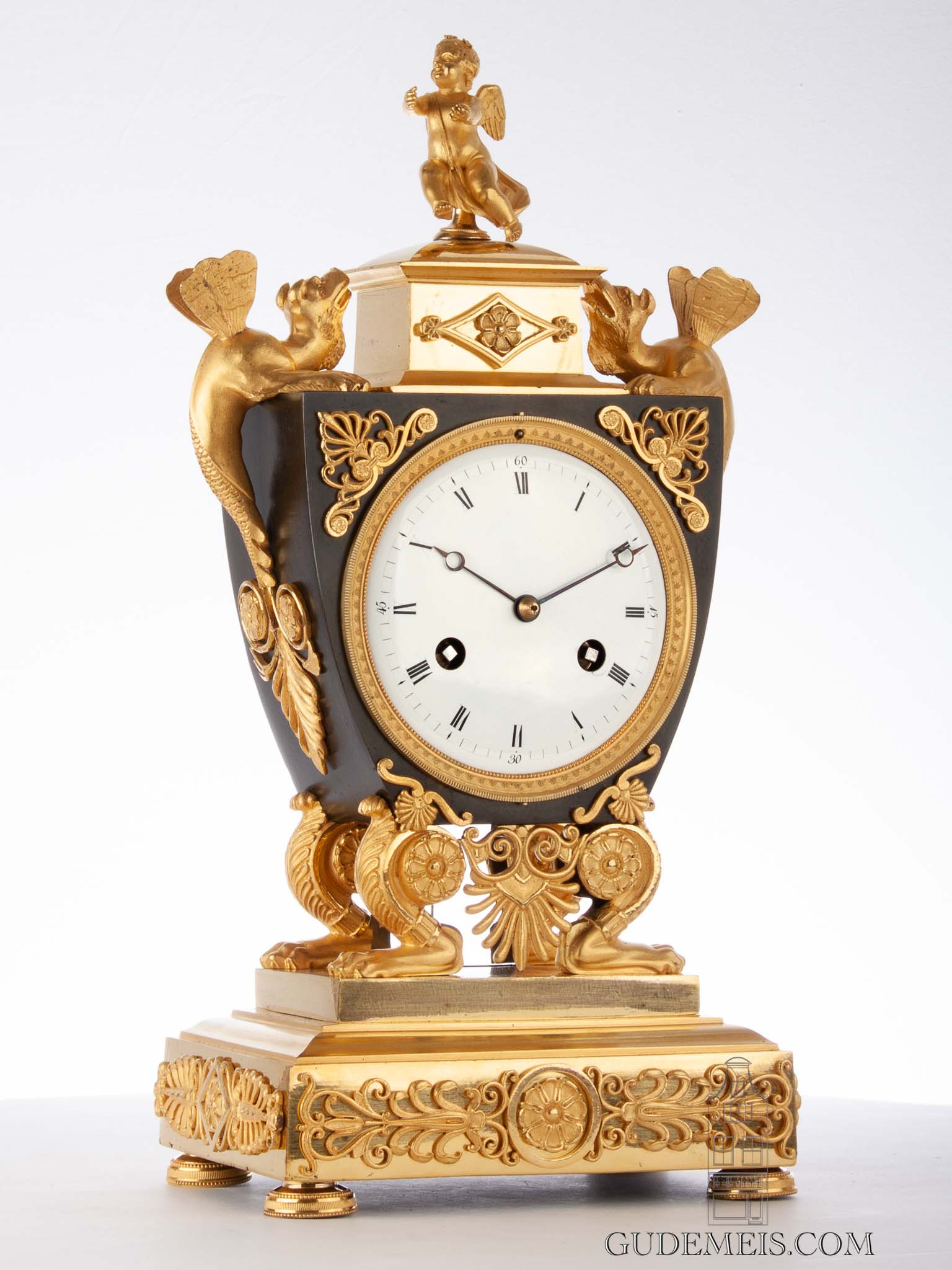 A rare French gilt and enamel 'bras en l'air' mantel clock, circa